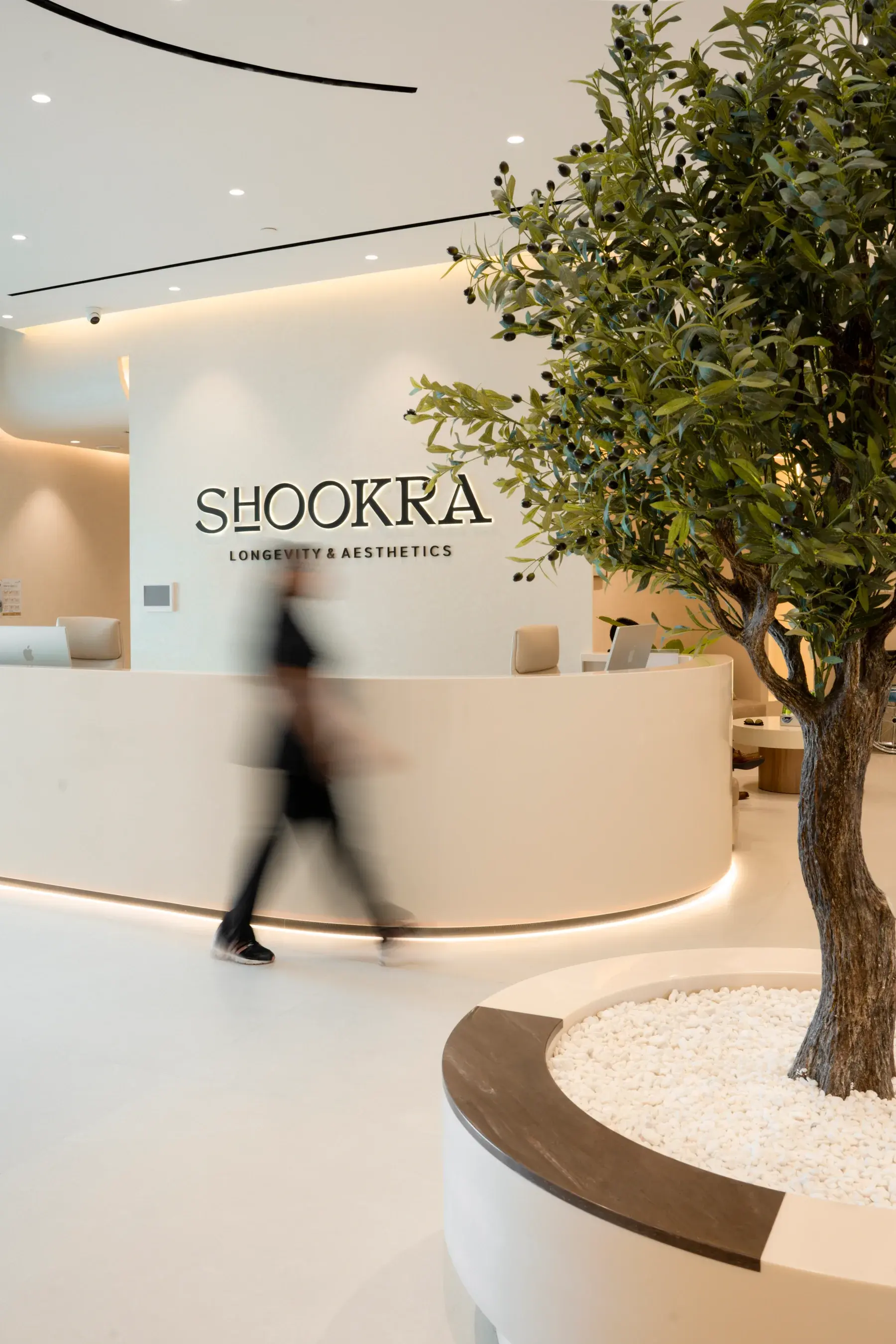 A member of staff crossing the reception at Shookra Palm Jumeirah, Dubai