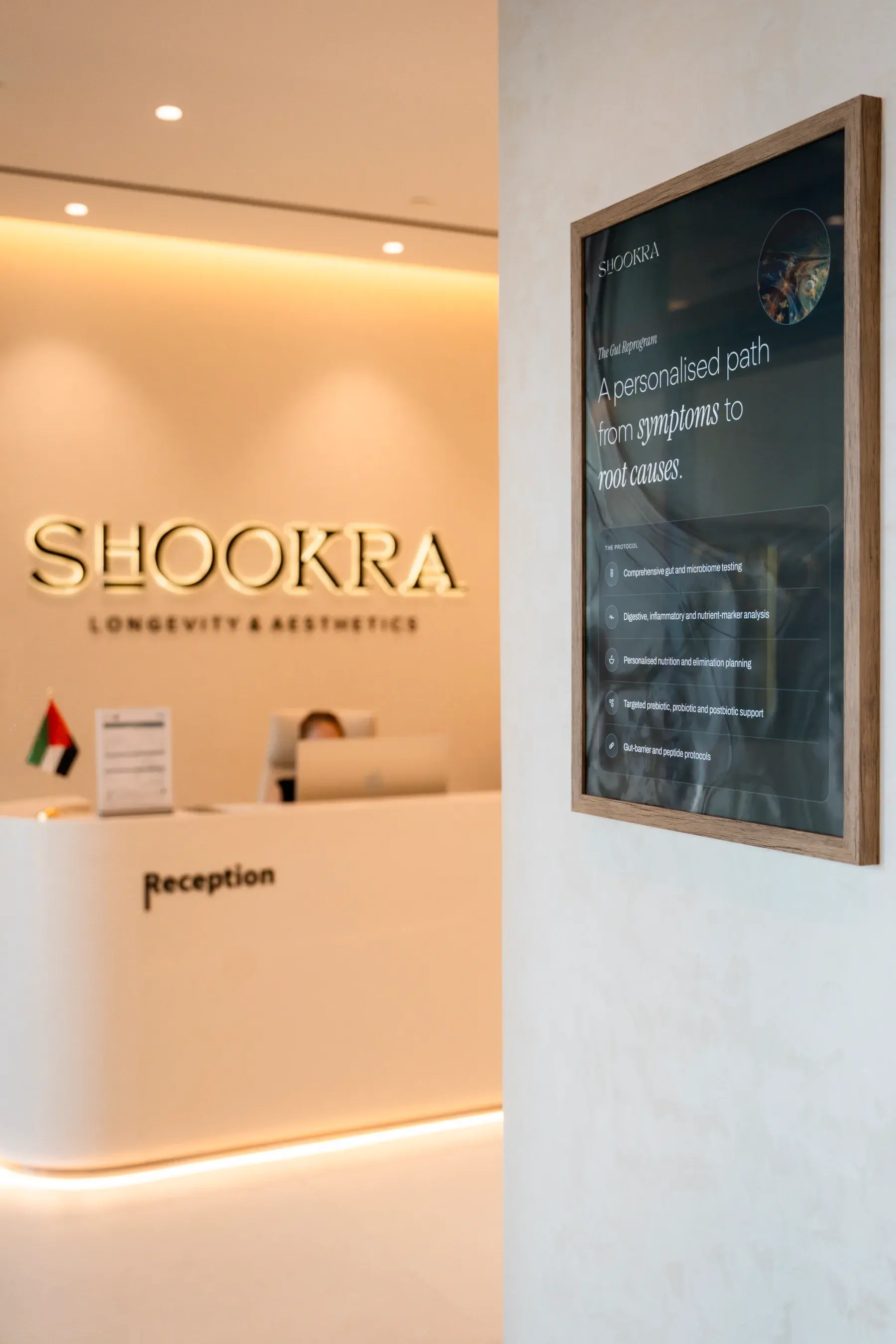 The reception desk at Shookra Palm Jumeirah, Dubai, beside a framed protocol notice